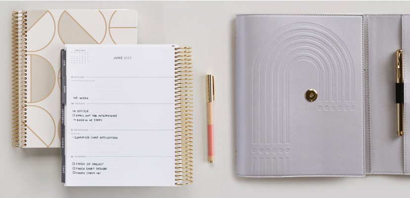 Overhead view of two stacked Focused Planners alongside a Harbor Arch A5 Focused Weekly Planner Ring Agenda.
